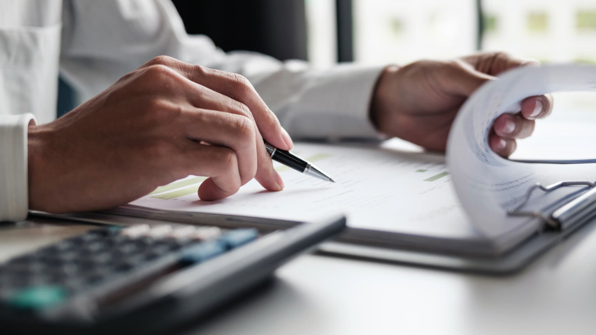 Person reviewing shipping documents with a pen – planning and handling liftvan transports